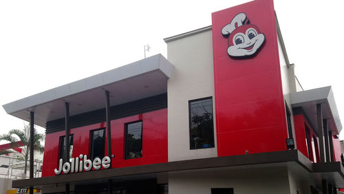 Low angle view of sign on building against sky