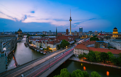 Aerial view of bridge over river amidst buildings in city