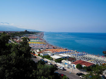 High angle view of cityscape by sea against sky