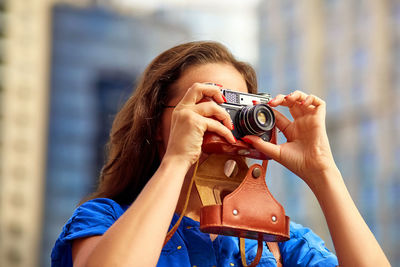 Portrait of woman photographing