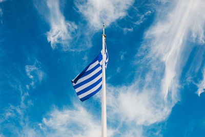 Low angle view of flag against blue sky