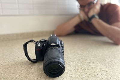 Midsection of woman photographing on table