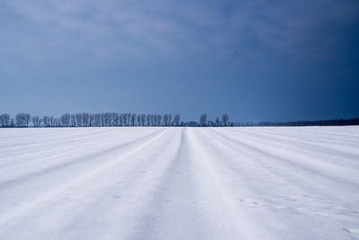 Snow covered field against sky