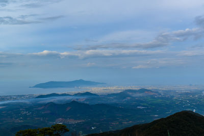 Scenic view of mountains against cloudy sky