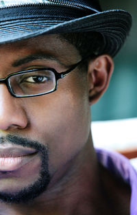 Close-up portrait of serious man wearing hat