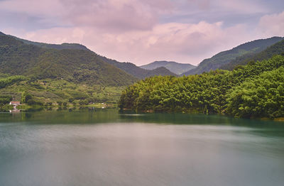 Scenic view of lake and mountains against sky