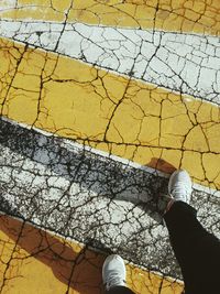 Low section of man standing on tiled floor