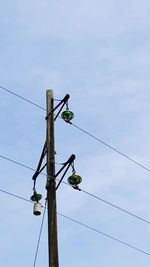 Low angle view of power lines against sky