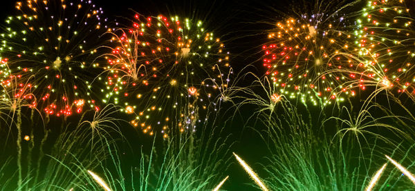 Low angle view of firework display at night