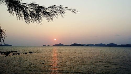 Scenic view of sea against clear sky at sunset