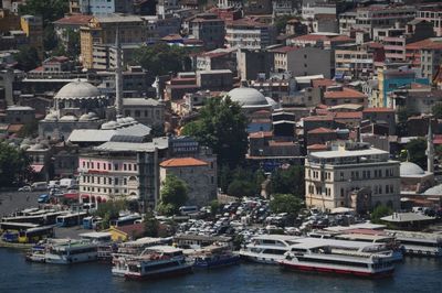 Boats in harbor with buildings in background