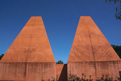 Low angle view of monument against blue sky