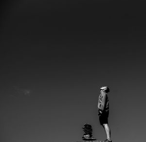 Side view of man standing against sky