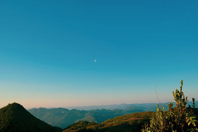 Scenic view of mountains against clear blue sky