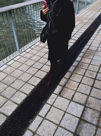 Close-up of woman standing on wall