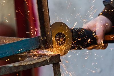 Low angle view of man working on metal