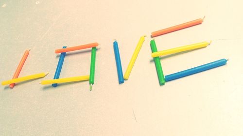 High angle view of colored pencils on white background