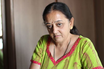 Close-up portrait of woman door at home