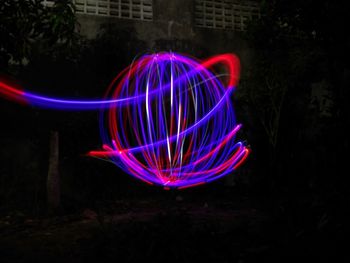 Light painting against trees at night