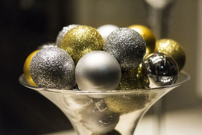 Close-up of shiny decoration balls in glass bowl