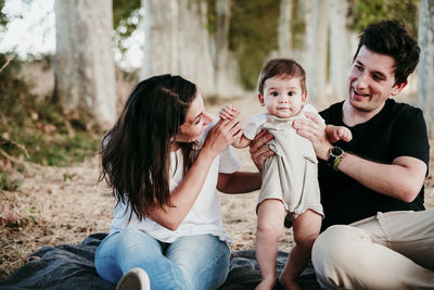 Father and son sitting outdoors