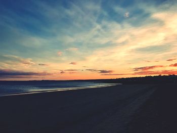 Scenic view of beach against sky during sunset