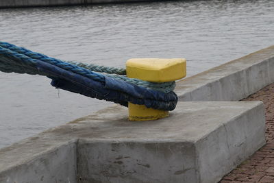 Close-up of yellow tied on rope
