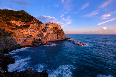 Rock formation in sea against sky