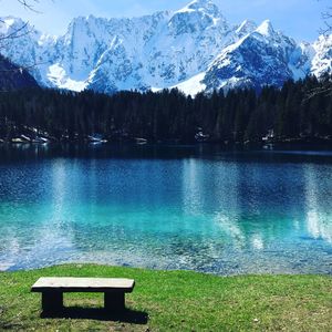 Scenic view of lake by snowcapped mountains