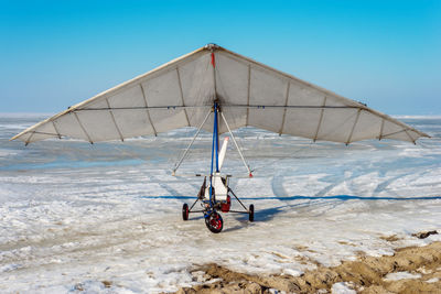 White sport hang glider on an ice field