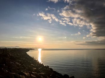 Scenic view of sea against sky at sunset