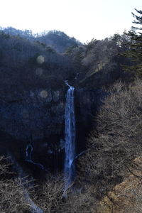 Scenic view of waterfall against sky