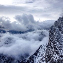 Scenic view of mountains against cloudy sky