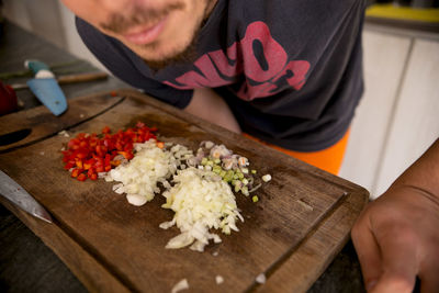 High angle view of man holding food on table