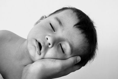 Close-up portrait of boy against white background