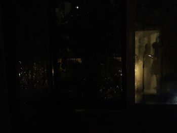 Illuminated building seen through glass window