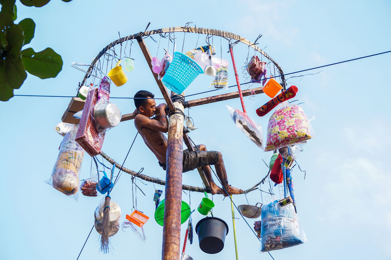 LOW ANGLE VIEW OF DECORATION HANGING AGAINST SKY