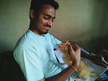 Young man sitting on table at home