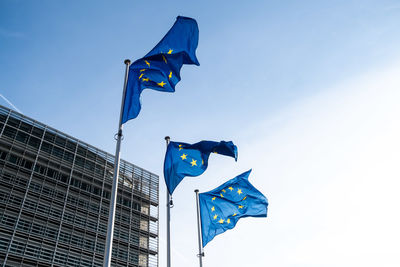 Low angle view of flag against blue sky