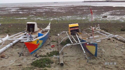 Boats moored on beach