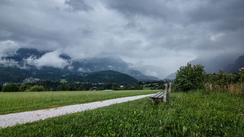 Scenic view of field and mountains against sky