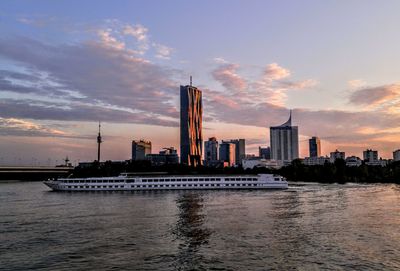 View of city at waterfront during sunset