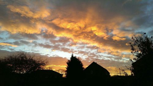 Low angle view of building against sky at sunset