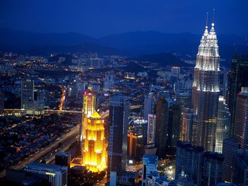 High angle view of city lit up at night