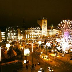 Illuminated ferris wheel at night