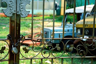 A locked compound with old things, old trucks in frame. 