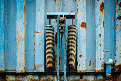 Close-up of padlock on wooden door