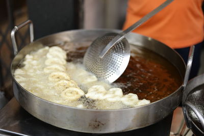 Midsection of man preparing food at street market