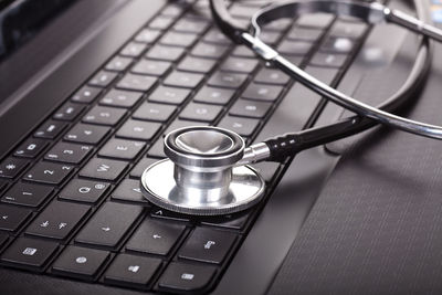 Close-up of stethoscope on laptop