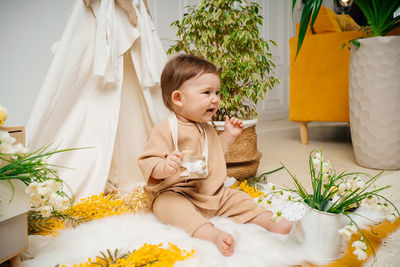 Portrait of smiling girl playing with christmas tree